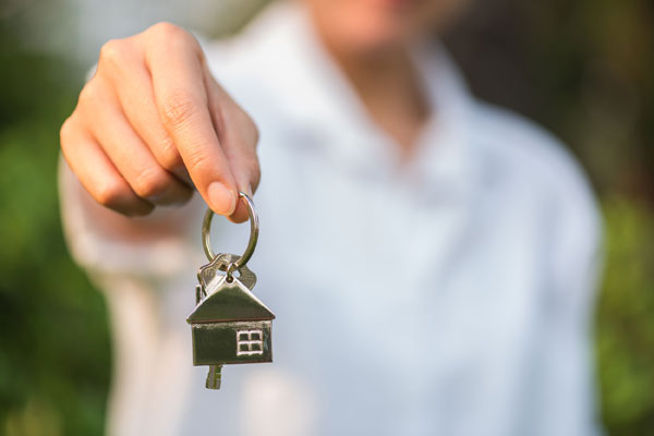 Holding Key chain with a house symbol attached